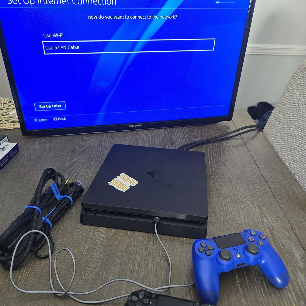 Sony PlayStation 4 Console with Black and Blue Controllers